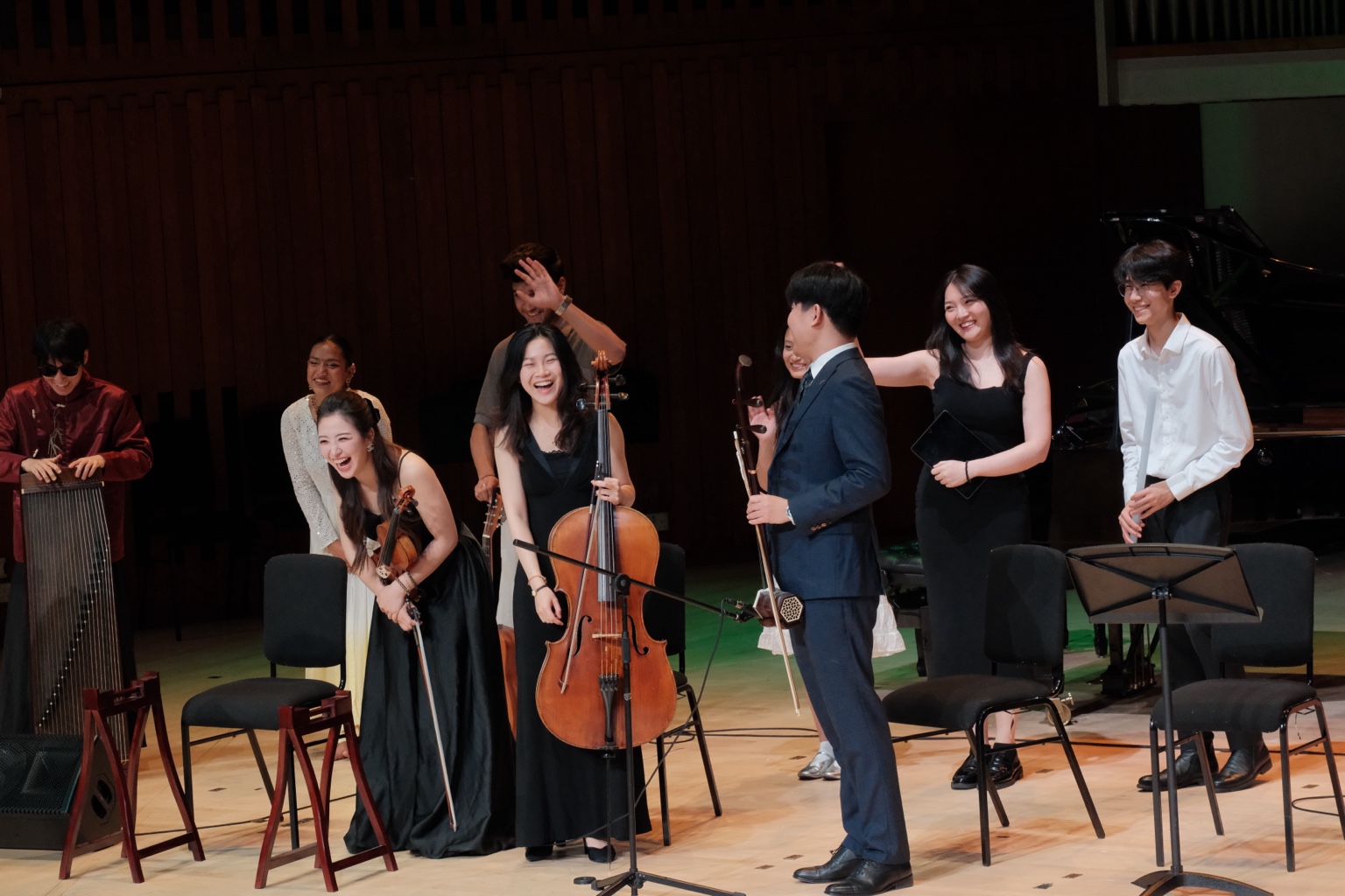 Musicians together on stage after a performance
